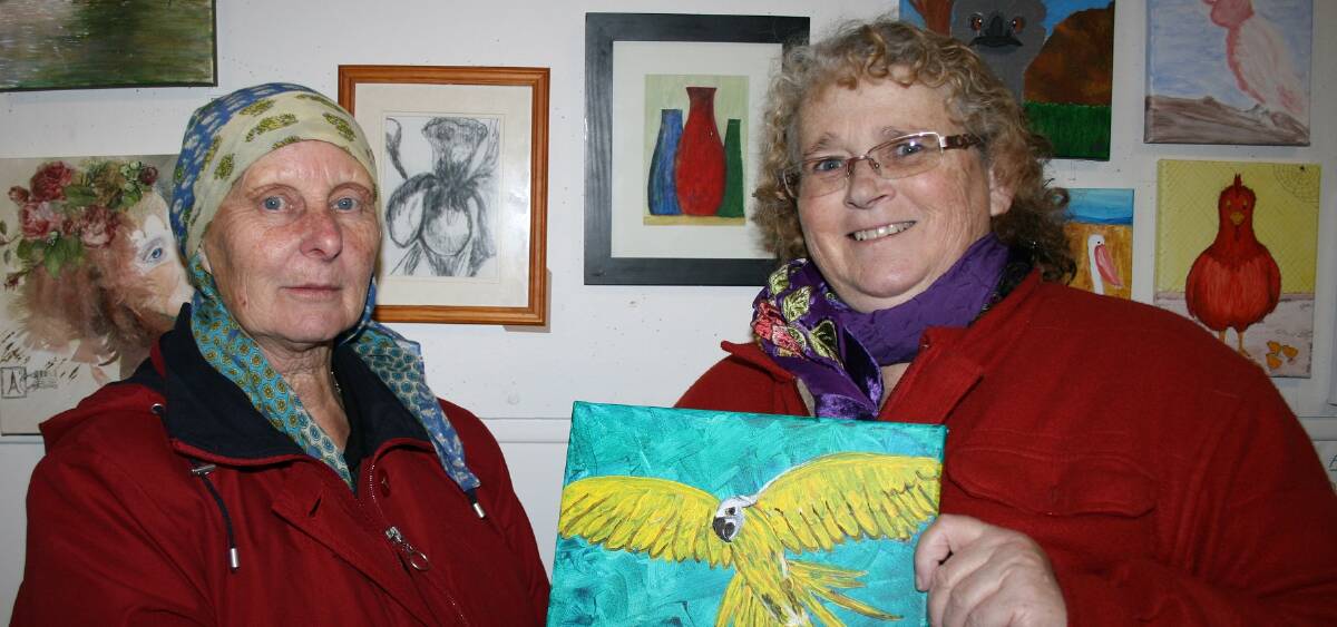 Rose Evans exhibited: A selection of watercolours and charcoals. Helen Vowles is holding her yellow Macaw painted with acrylic.