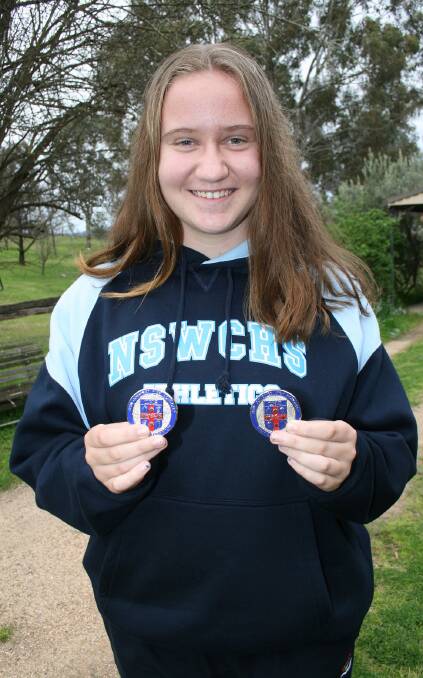 Going for Gold: Teleisha Besant with her two silver medals gained at the State Athletics Championships.