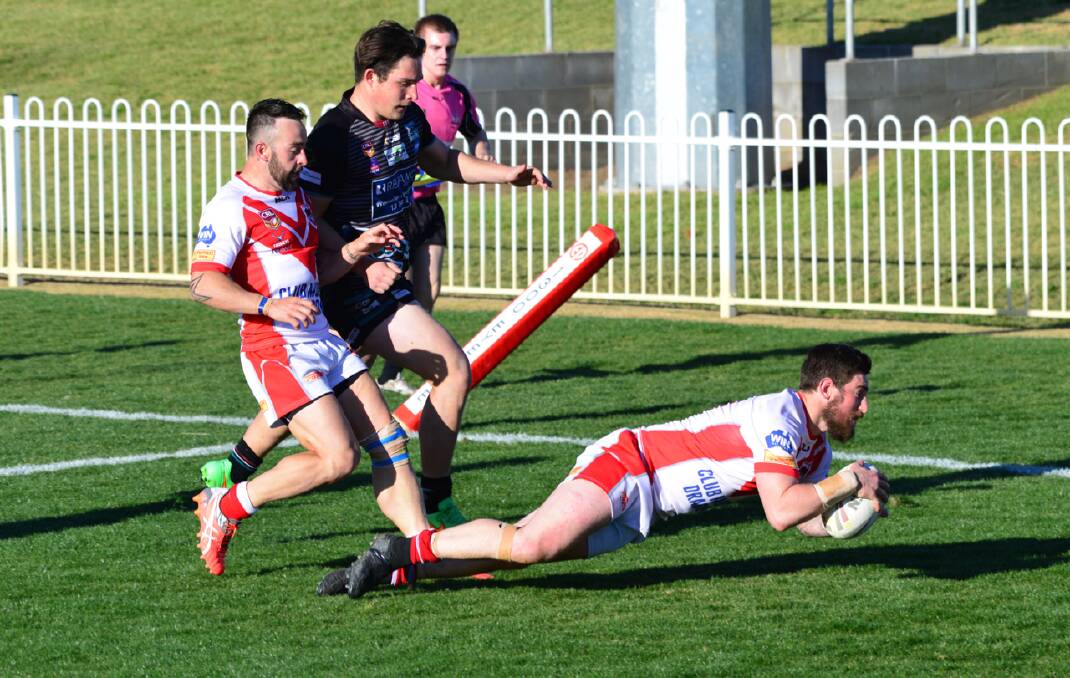 Chris ward scores for the Mudgee Dragons in their match against Bathurst Panthers on Sunday.  Photo:   Col Boyd. 