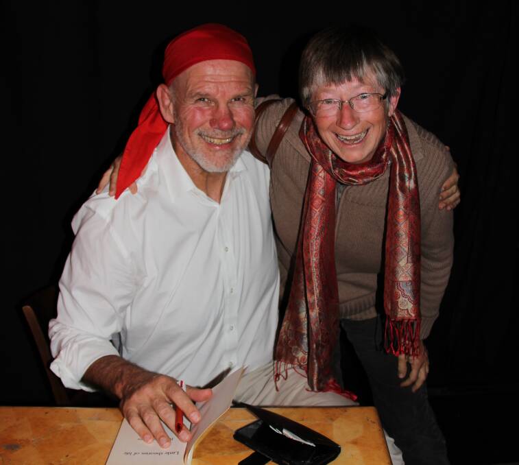 Australian Republican Movement chairman Peter FitzSimons signs a book for Helen Chisholm at the Mudgee forum on Monday night. 