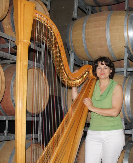 Harpist Alice Giles rehearses in the barrel room at Huntington Estate. 