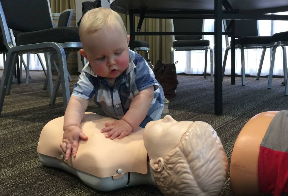 Starting early:  A young "Saving Little Ones" participant gets an early start on resuscitation training. 