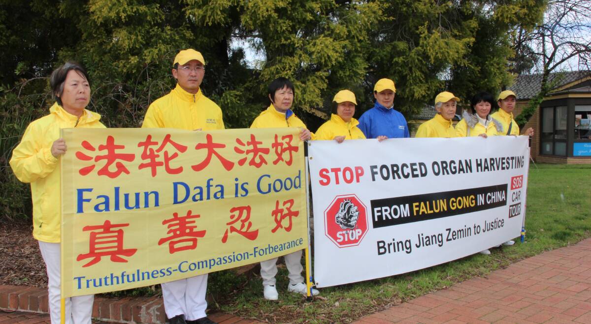 SOS: Tony Lui (second from left) and fellow Falun Gong practitioners outside the Mid-Western Regional Council chambers.