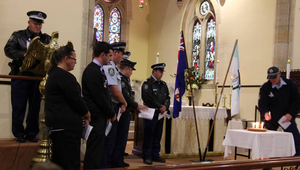 Remembrance:  Police officers lit a candle for each of the officers who have died in the past 12 months. 