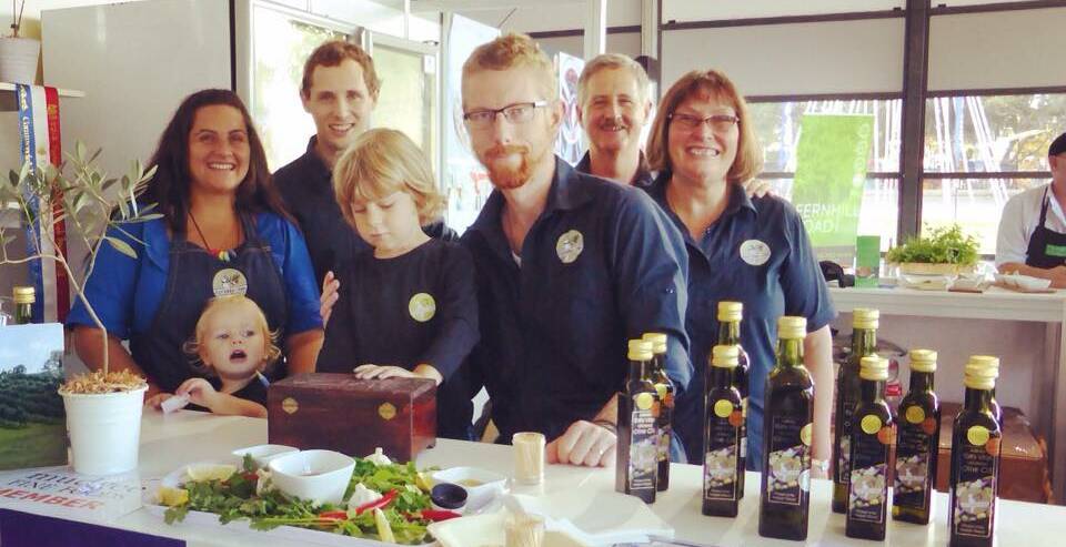 GOLD IN A BOTTLE: Phil and Amanda Carkagis and the team at East Ridge Olives with their gold-medal winning product. 