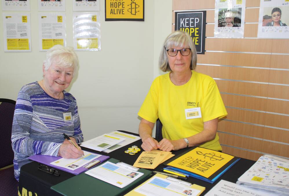 WRITE ON: Trish Feast with Heather Drew of Amnesty Mudgee at the Mudgee Library on Friday. 