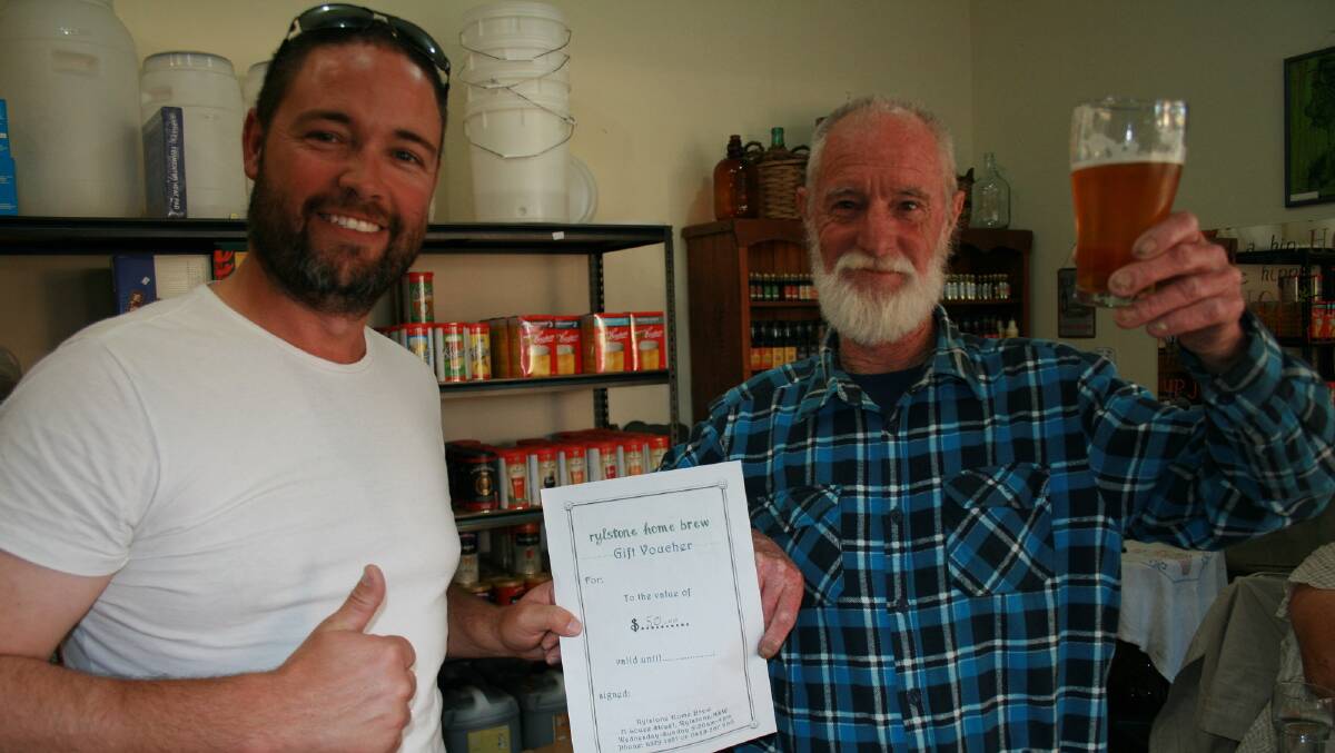 CHEERS: Hayden Burlington congratulates Geoff Hughes on taking out the inaugural home brew beer brewing competition.