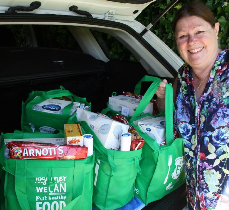Legatee Barbara Eordogh loading up her vehicle with Christmas hampers for local distribution.