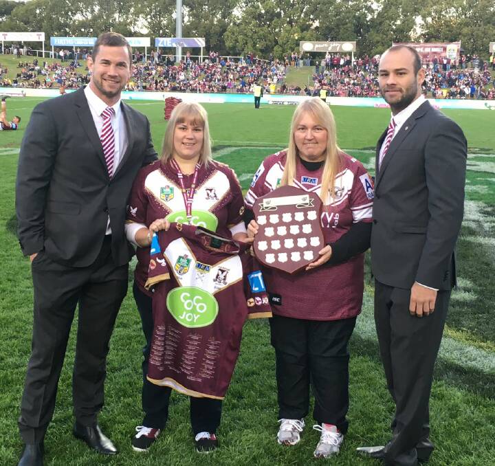 Proud moment: Kylie and Sue Mitchell accept their Manly Member of the Year award from Brenton Lawrence and Brett Stewart at Brookvale Oval. 