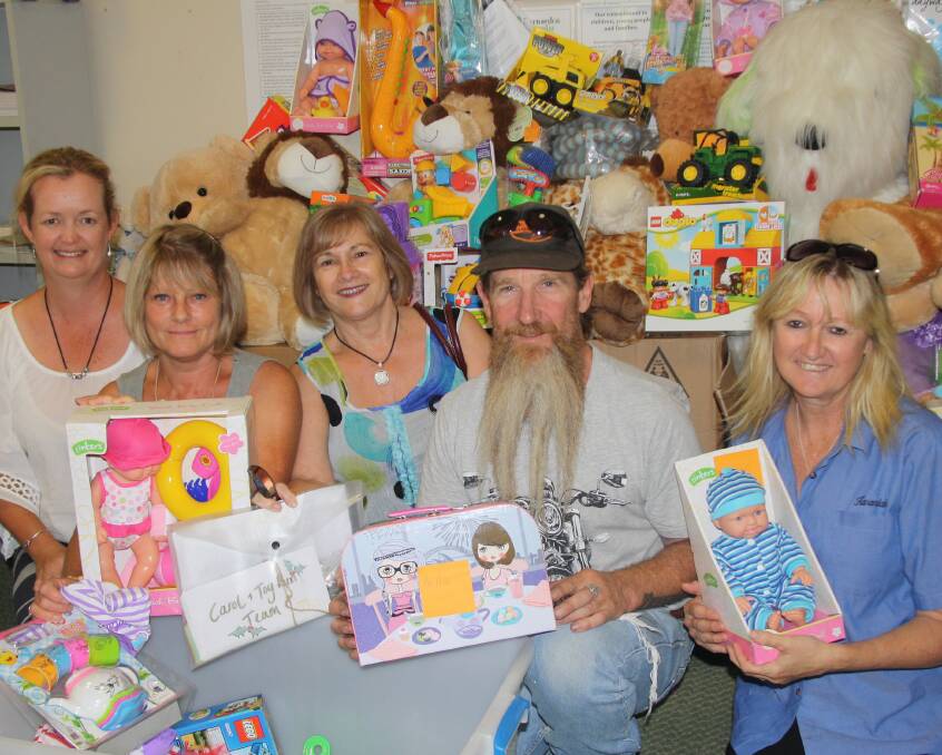 TIME OF GIFTS: Kate Cormie, Caroline Santas, Carol Jones, Crash O'Brien and Toni Wood with some of the toys donated to the Toy Run. 
