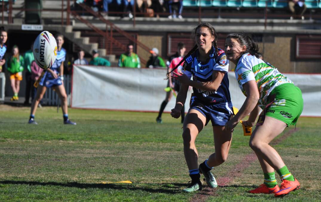 GOING WIDE: Hawks fullback Erin Naden sends the ball left during the derby at Wade Park.