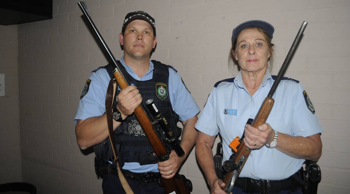 NEW LAWS: Senior Constable Matt Holden and Senior Constable Sue Rose, discussing firearm security at home. Photo:CHRIS SEABROOK