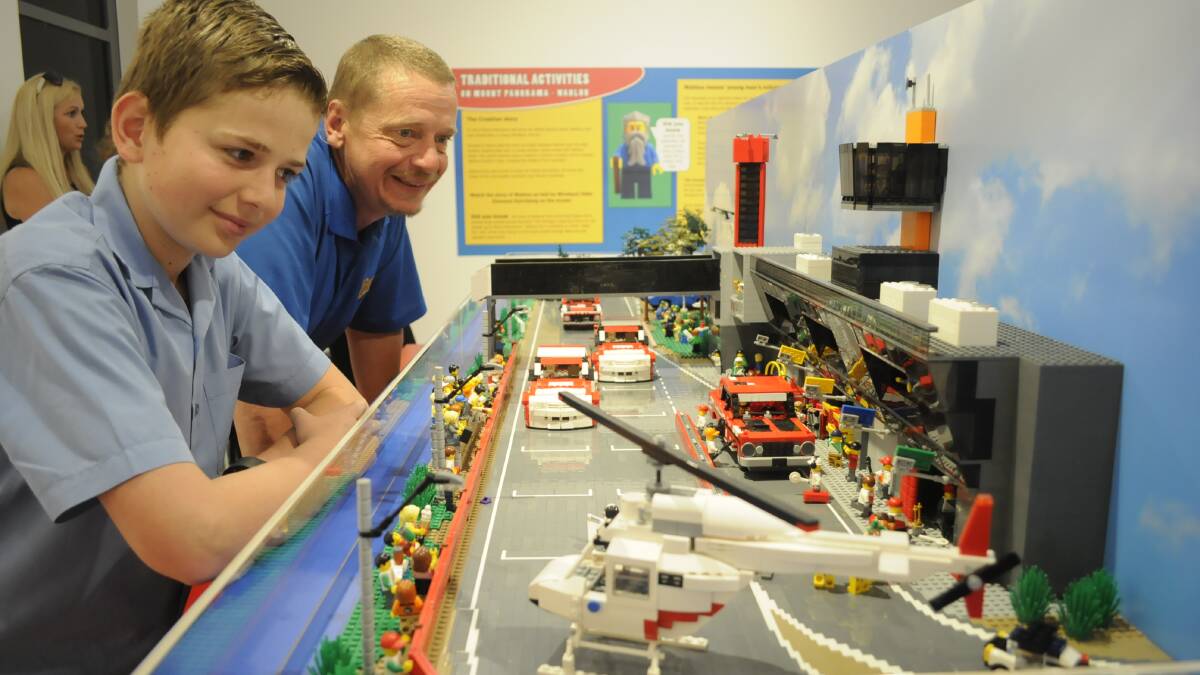 GREAT EXHIBIT: Will Starkey (11) and his dad, Pete, having a close look at the Pit Straight model made of LEGO. It is on display at Bathurst Regional Art Gallery (BRAG) until the end of January. Photo: CHRIS SEABROOK 113016clego1