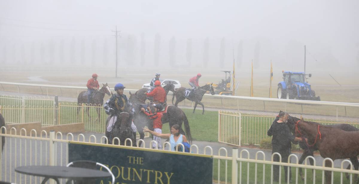 Heavy downpour: The weather was extreme at the Country Championships meeting at Mudgee on Sunday afternoon. Photo: SIMONE KURTZ