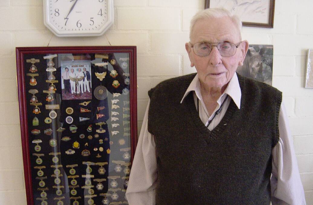 Doug pictured with some of the many medals achieved for bowls.