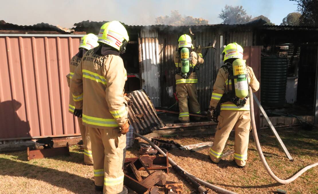 ACCESS: Firefighters attempt to gain access to a structure fire in Kandos on Tuesday. Photo: Fire and Rescue NSW.