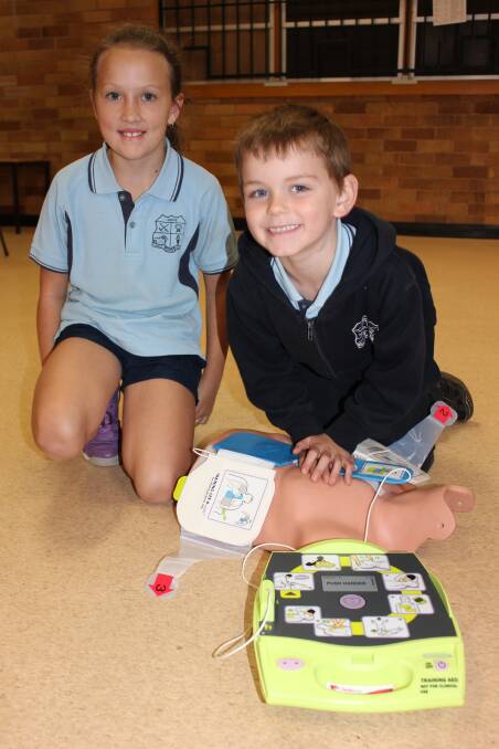 Students Indiana and Brent demonstrated how the AED works.