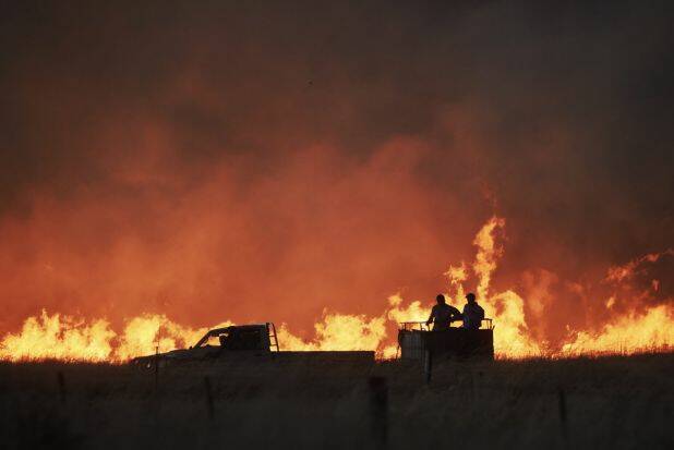 Farmers race the front of the Sir Ivan fire in February. Photo: Nick Moir