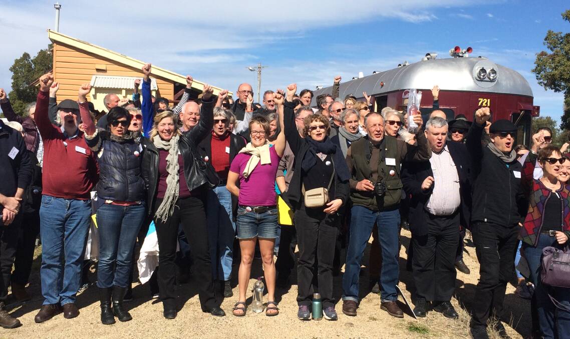 Cheers: More than 80 people rode the Rail Motor Society 600 Class heritage train from Maitland to Gulgong on Sunday through the Hunter and Western coal fields to see the consequences of coal mining on communities.