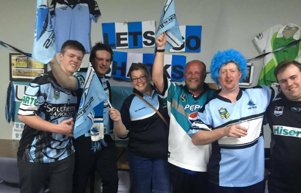 Historic moment: Greg Reid (second from left) celebrates with some of the Cronulla faithful at the Gulgong Bowling Club on Sunday. Photo: SUPPLIED