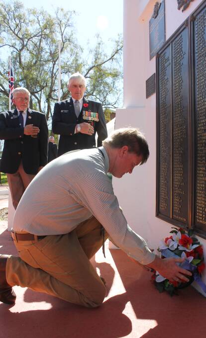 Craig McConnell - whose uncle died in the Vietnam War - lays a wreath at the Gulgong service, also pictured is the Sub-Branch's Peter Leotta and David Henderson.