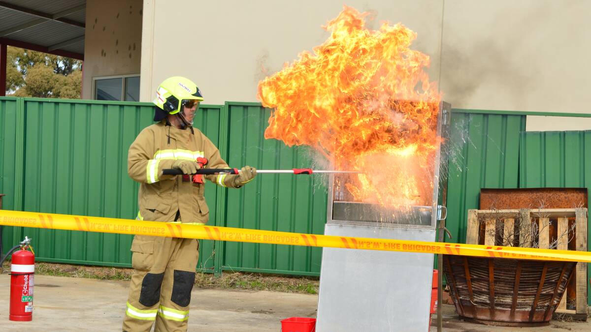FIRE UP: The annual Fire Station Open Day will be held at Mudgee, Gulgong and Kandos, between 10am and 2pm on Saturday, pictured is Ashley Mackie giving a demonstration of what not to do with a hot oil fire. Photo: Col Boyd. 