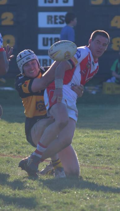 WHERE THERE'S SMOKE: Ben Thompson offloads despite attention from Jackson Brien in Mudgee's win over Oberon in week one semi-finals. Photo: ALEX GRANT