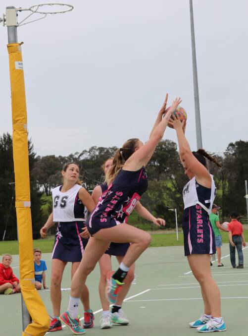 OVER THE TOP: Starlets See Thru's Beth Chilcott defending Starlets Paragon Jen O'Brien, her defence a big part of her team's Mudgee District Netball Association Division 1 grand final win.