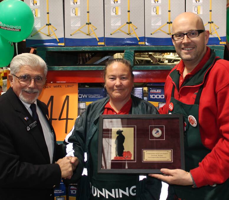 Gulgong RSL Sub-Branch vice president Peter Leotta presents Bunnings Mudgee's Kerry Miller and Jeff Telley with a memento of the organisation's gratitude for their support of the sub-branch.