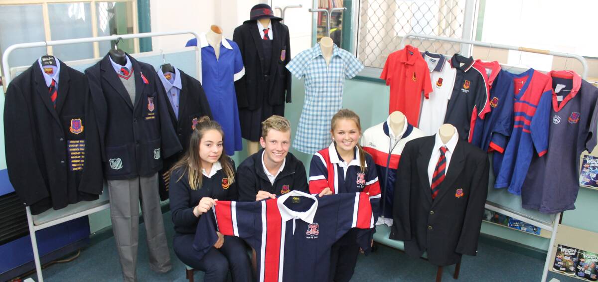 SCHOOL COLOURS: Current Mudgee High students Madi Hayes, Lachie Wall and Andrea Holden, at one of the school's uniform displays ahead of this weekend's centenary.