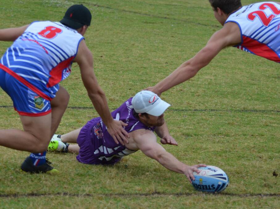 REACH OUT: Mudgee's Justin Gossage diving for a touchdown for the Mudcrabs against Newcastle (20s) in the Men's Open division of the Country Championships.