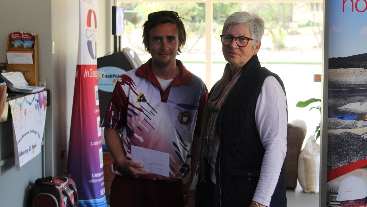 Mudgee's Cody Graham from the highest placed local team in sixth, pictured with Colleen Ryan of the Gulgong Bowling Club.
