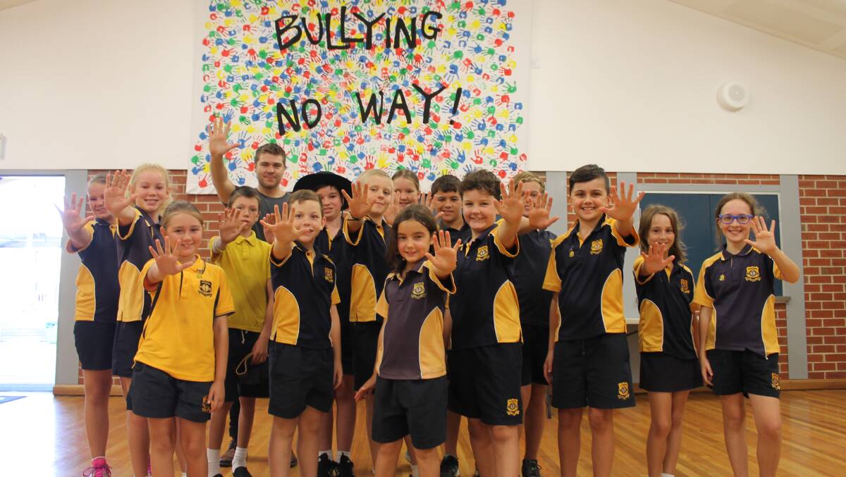 TAKE A STAND: Mudgee Public School Student Representative Council members and special guest, motivational speaker and magician Lewis Ramsay, say "Bullying, No Way".