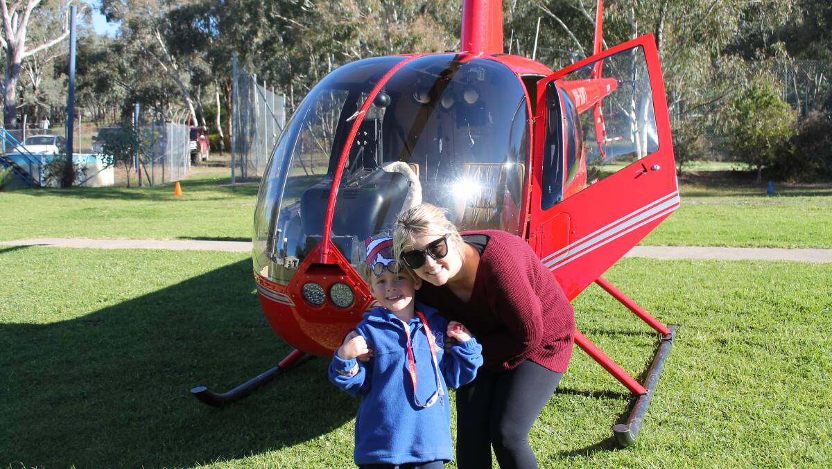 TO THE SKIES: Lue Public School student Tyler Charters was the lucky winner of the helicopter flight raffle, along with accompanying teacher Teagan Heraghty.