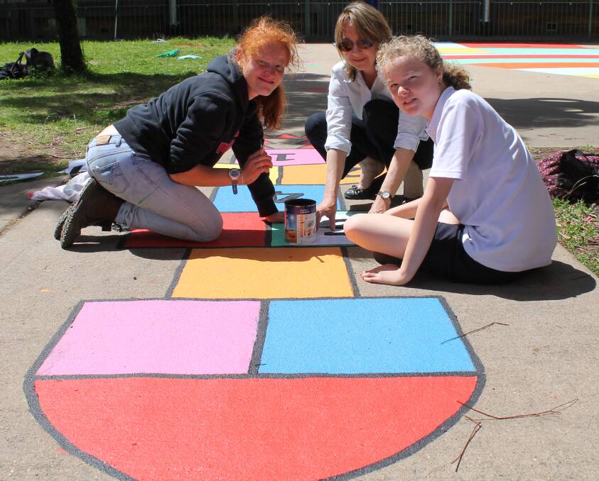 SPLASH OF COLOUR: Mudgee High School students Destiny Thorpe and Sharna Chadwick, with some assistance from Carol Chadwick, add some colour to the special education area.
