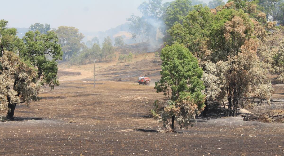 AFTER BURN: Rural Fire Service crews worked on containment lines at the Kains Flat fire on Thursday.