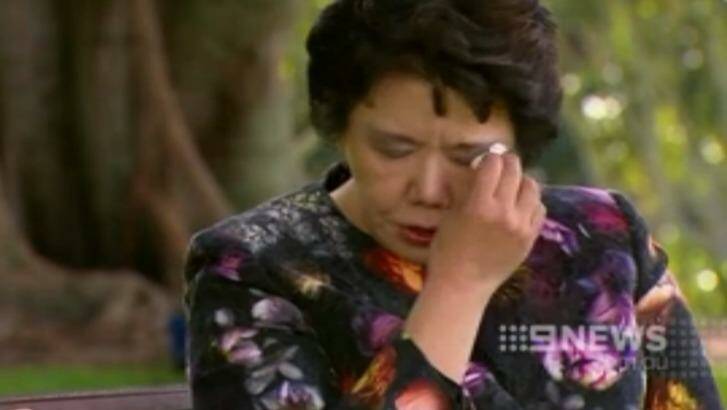 Selina Cheng dabs her eyes as she speaks about her murdered husband. Photo: Nine News