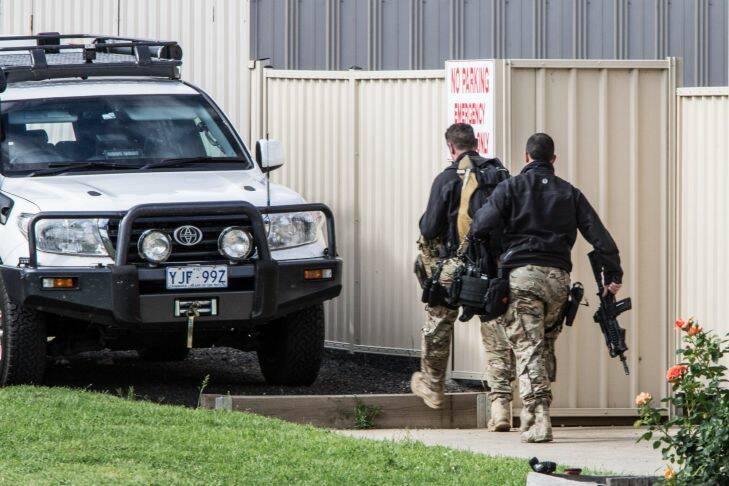 Special Operations Group officers gather in Yea in a massive manhunt for the  elusive father and son Gino and Mark Stocco in bush north of Melbourne
in October 2015. Picture: Jason South