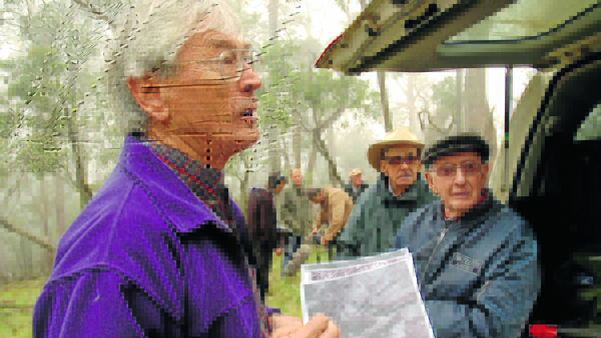 DIFFICULT SEARCH: Dick Smith, Max Hazelton’s brother-in-law Selwyn Murray and Max Hazelton use photos to pinpoint the crash site. 
Photo: DENIS GREGORY
