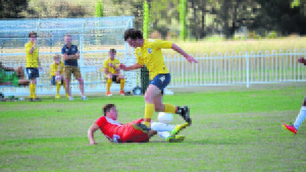 TAKE DOWN: A Rydalmere player steals the ball from a Western Mariners rival. 141214bhmariners