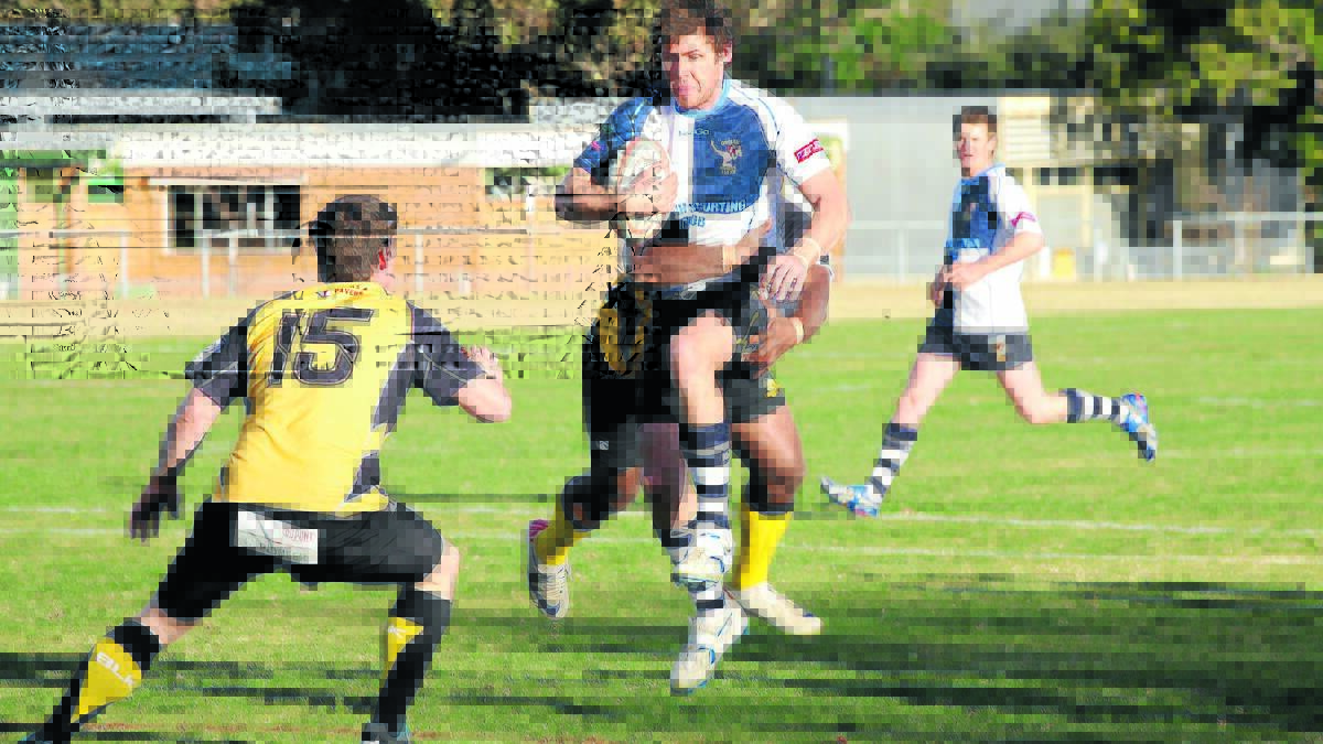 BUSINESS END: Coolah’s Jace Russell takes on the Dubbo Rhinos Gold defence during the season. The GrainCorp Cup northern conference begins their semi-finals this weekend with Yeoval meeting Coolah in the qualifying semi and Wellington hosting Dubbo Rhinos Black in the elimination semi. Photo: NATALIE GHIGGOLI 	060714