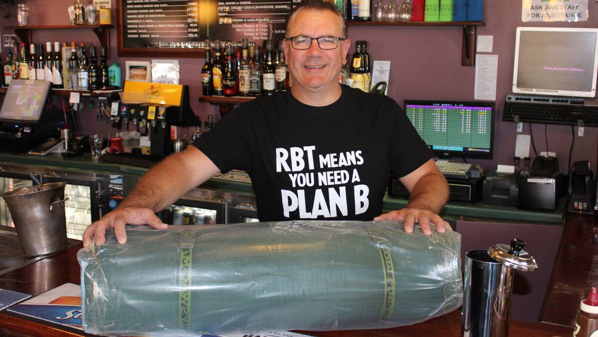  Publican and Mudgee Liquor Accord chairperson Paul (Ozzy) Osseweyer with one of multiple swags being given away as part of a joint campaign to curb the region’s high drink driving rates. 