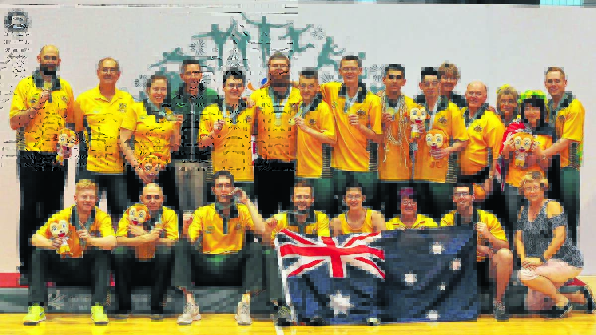 Jordan Woolmer (back row; five from left) and the Australian Goannas celebrate their gold at the 2015 Asia Pacific Deaf Games. Photo: Vicky Corrigan 