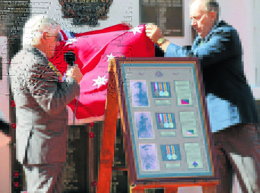 UNVEILED: Gulgong RSL Sub-Branch President David Henderson and Mal Watt unveil the memorial to Gulgong’s Watt brothers who all fought and died in World War I.
