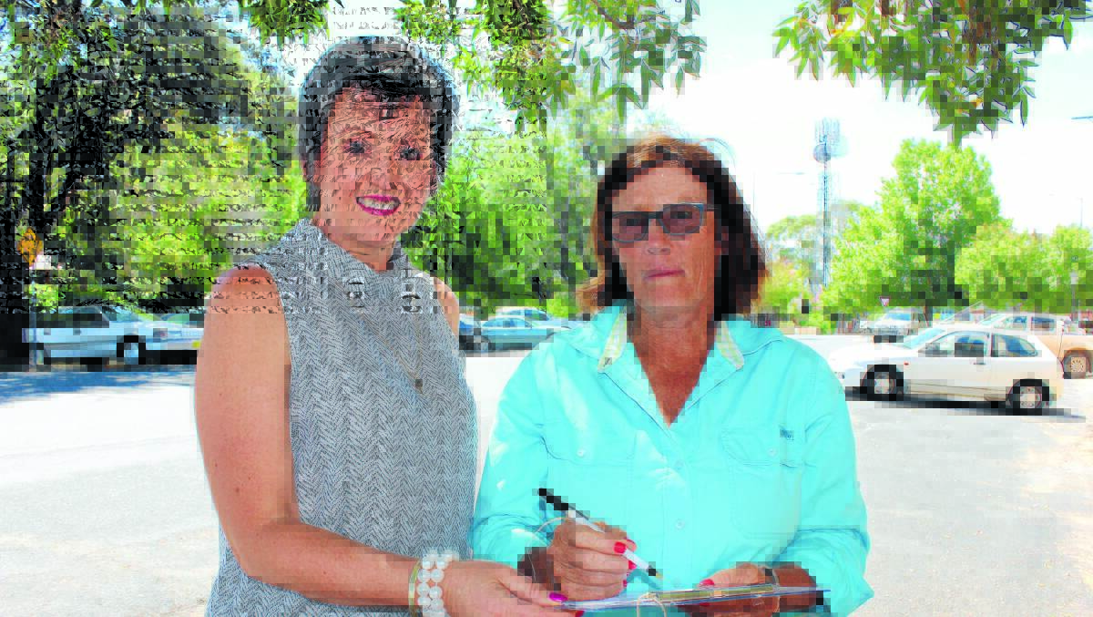 No Central Waste Nuclear Dump chairwoman Robyn Rayner with Triamble resident Shelley Roydhouse signing a petition calling for Hill End to be withdrawn from the sites being investigated as the location of a radioactive waste dump. 