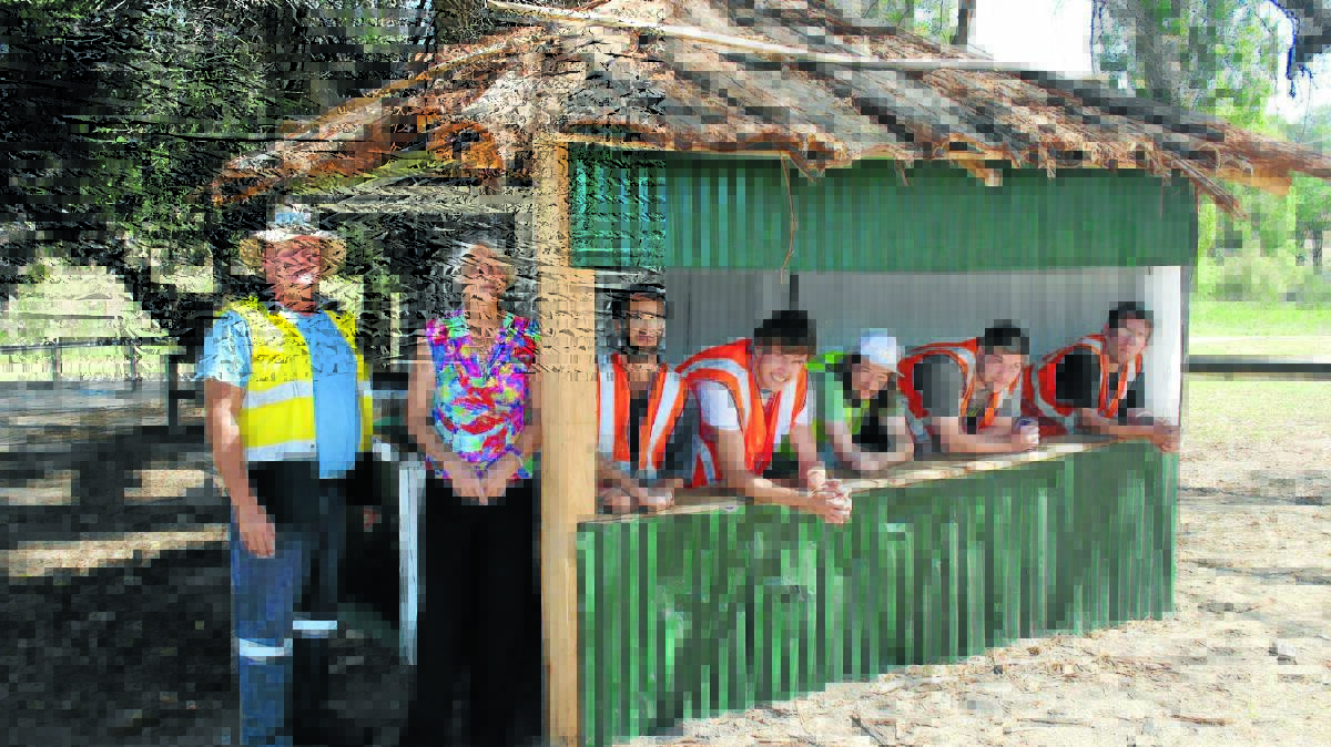 Supervisor Steve Mylchrest with show secretary Nancy Keck and Helping Hands Up participants Isaac, Jake, Nathan, Scott and Scott celebrating the completion of the renovation of the former blacksmith’s hut.