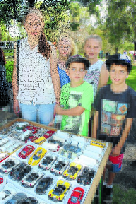 Bernadette, Maddison, Jacqueline and Brandon King admire toy cars at the Lawson Park Markets.