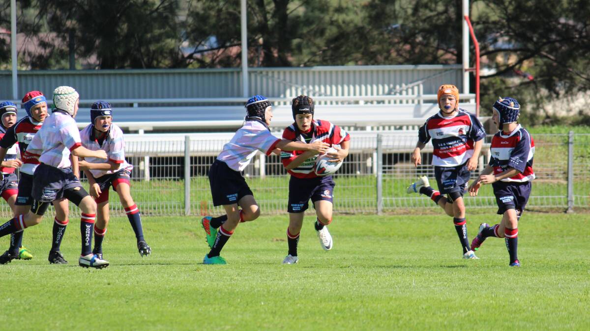 Mudgee Wombats under 13s Red player Charlie Slacksmith meets the Wombats Blue defence at Jubilee Oval on Saturday. PHOTO: DARREN SNYDER