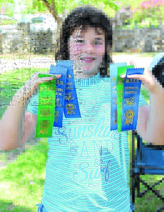 Clare Cahdwick with the six ribbons she won on the day from seven races.