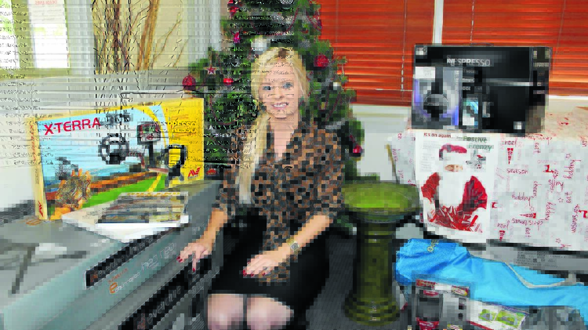 Mudgee Guardian Advertising Representative April Memorey with just some of the prizes available in this year’s Festive Frenzy promotion.